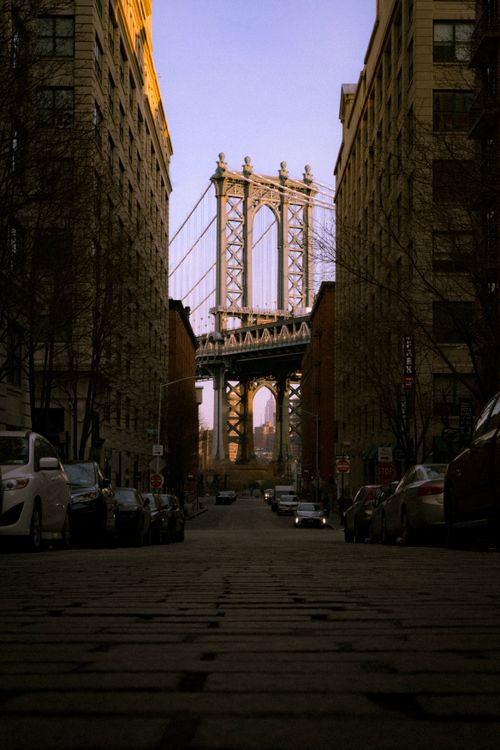 Free Stunning vertical shot of the Manhattan Bridge seen from a street in DUMBO, highlighting urban architecture. Stock Photo