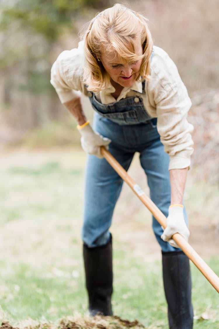 Photo Of An Elderly Woman In A Denim Jumper Gardening