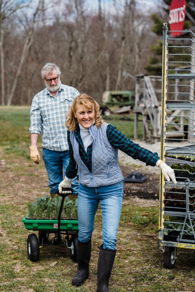 Smiling Elderly Woman Pulling A Wagon With Plants