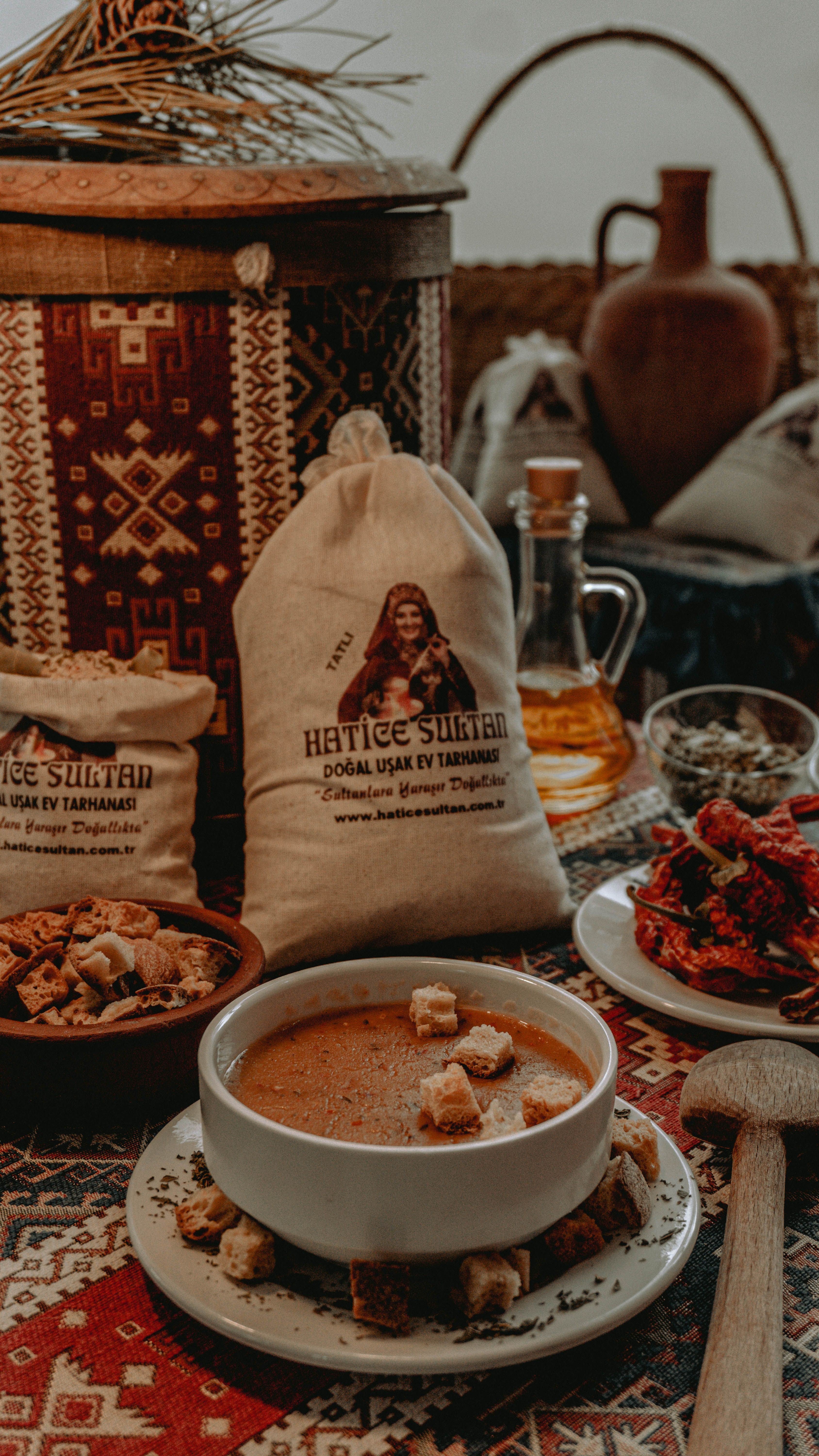 A warm bowl of traditional Turkish tarhana soup surrounded by rustic decor and ingredients.