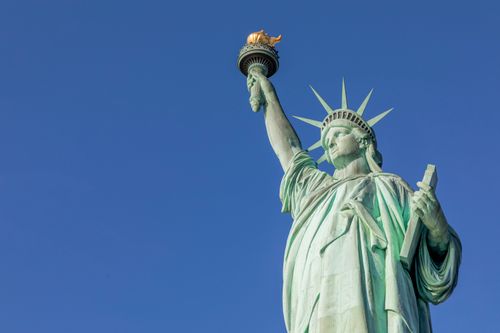 Free Iconic Statue of Liberty with a clear blue sky in New York City, USA. Stock Photo