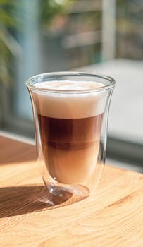 A close-up shot of a beautifully layered latte in a glass, perfect for coffee enthusiasts.