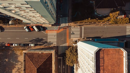 Aerial View of a Street Intersection Between Buildings
