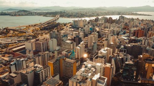 Free A breathtaking aerial view of Florianópolis featuring skyscrapers and the coastal skyline under a bright day. Stock Photo