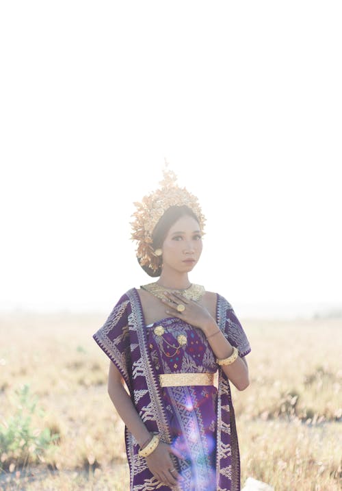 Free Woman in Traditional Clothes and Headdress Standing in the Field

 Stock Photo