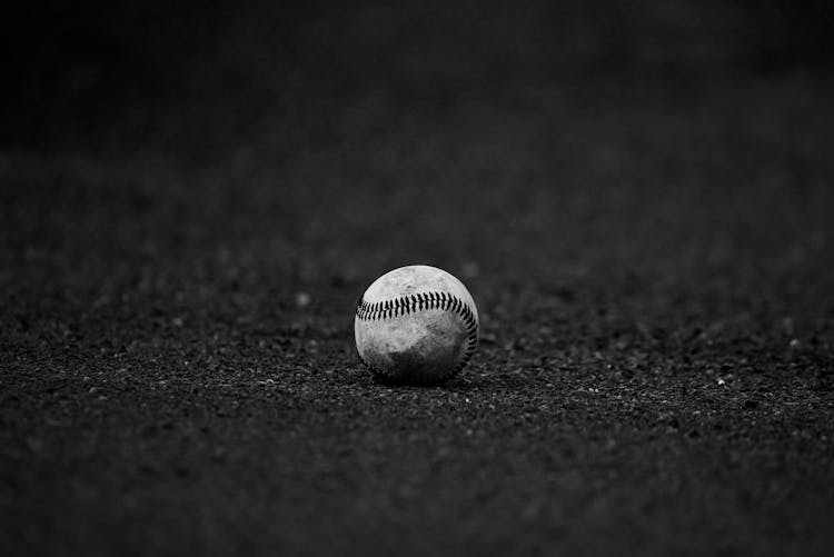 Selective Focus Grayscale Photography Of Baseball