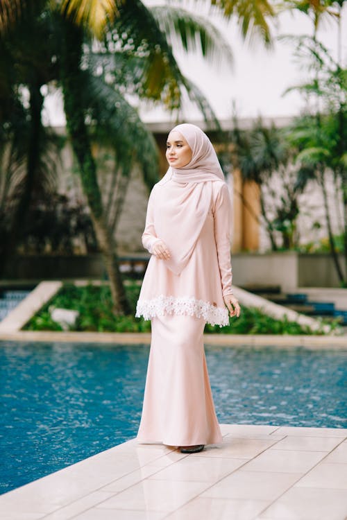Woman Wearing Hijab Standing Near a Pool