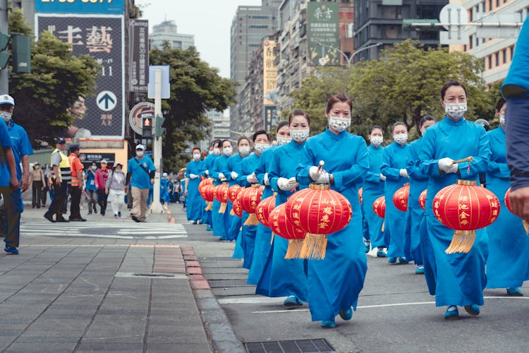 The New Normal Parade Of Chinese Lanterns By Women In Blue Dress 