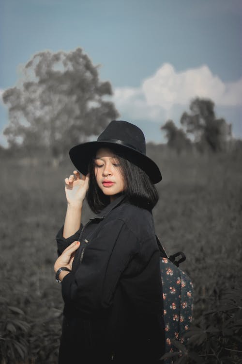 A Woman in Black Hat and Black Jacket