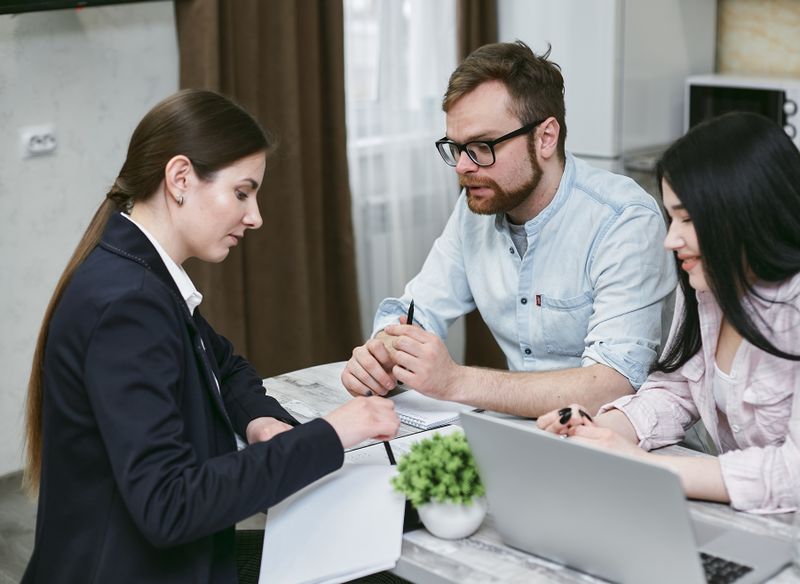 Advisor comparing insurance policy documents and household financial needs in Cape Town