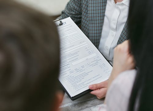 Free A Person Holding a Contract Document Stock Photo