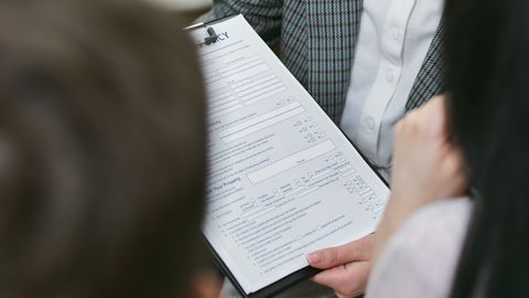 Close-up of professionals discussing a legal contract during a business meeting.