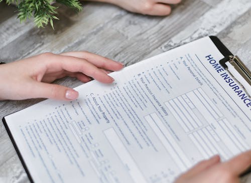 Free Person Holding Home Insurance Form Stock Photo