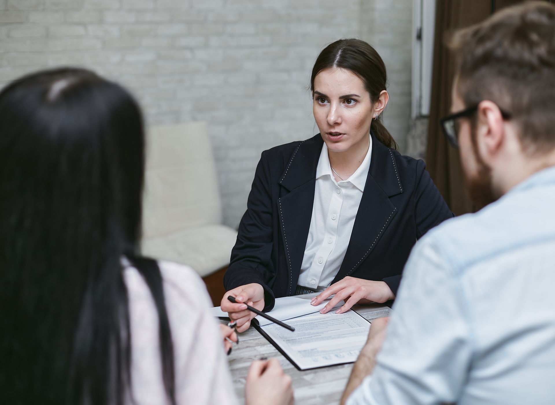Woman in Black Blazer Talking to Her Co-workers