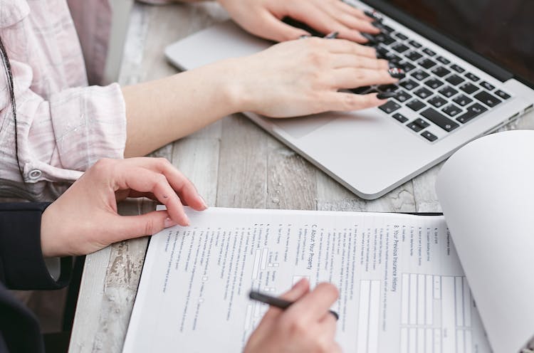 A Person Typing On Laptop