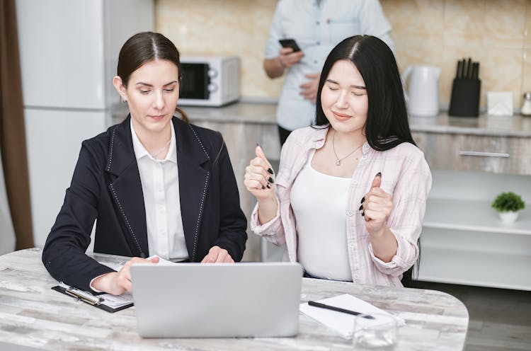 Women Looking At The Screen Of A Laptop