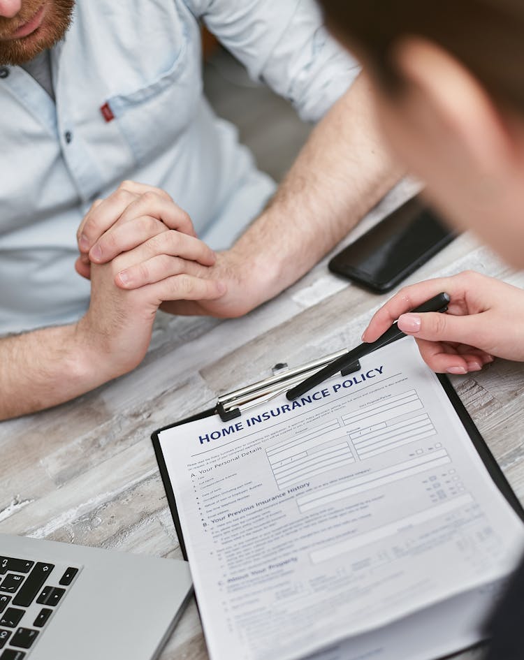 Close-up Shot Of A Person Pointing The Document On The Clipboard