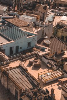 Aerial view highlighting diverse urban rooftops with warm tones and shadows.