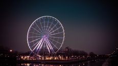 Photograph of a Ferris Wheel with Purple Lights
