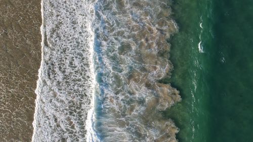 Free Captivating aerial view of ocean waves crashing on the beach in Australia. Stock Photo