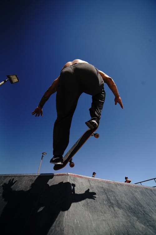Free Low-Angle Shot of a Man Doing Skateboard Tricks Stock Photo
