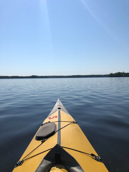 Photograph of a Black and Yellow Kayak on a Body of Water
