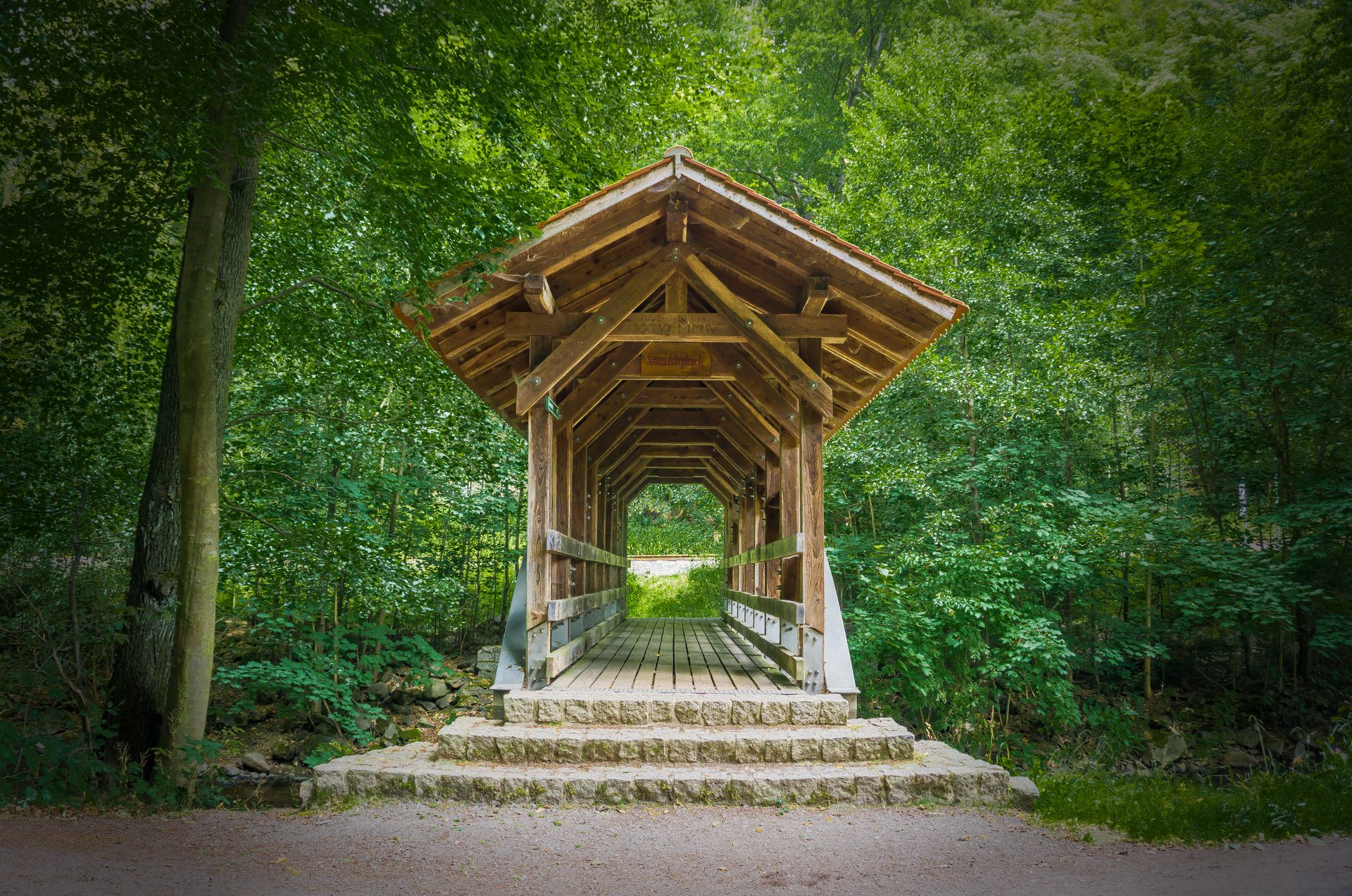 A picturesque wooden gazebo nestled in a vibrant green forest, offering a serene and tranquil setting.