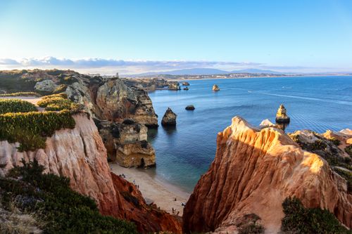 Free Breathtaking view of the Algarve cliffs and Atlantic Ocean under a blue sky. Stock Photo