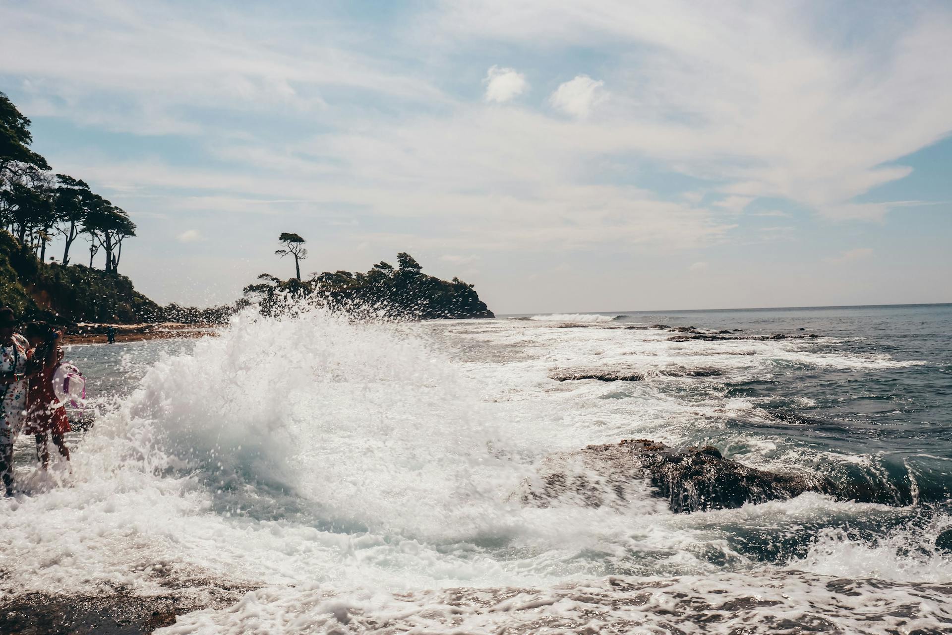 Stunning view of ocean waves crashing against a rocky shoreline, capturing the power of nature.