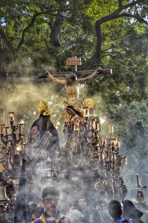 Free Dramatic scene of a religious procession with a crucifix and smoke rising through the air. Stock Photo