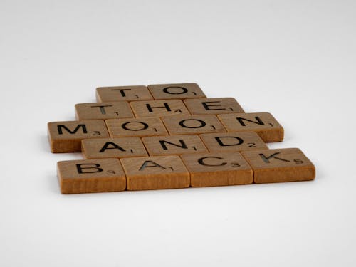 Free Wooden Scrabble Tiles on a White Surface Stock Photo
