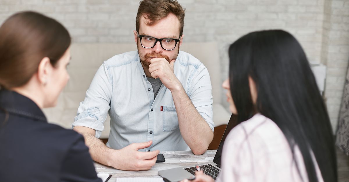 Three professionals having a real business meeting indoors