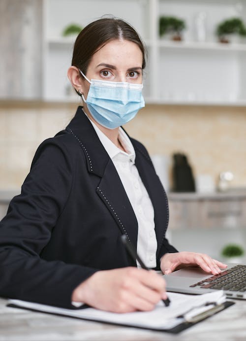 Free Shallow Focus of a Woman in Black Suit Wearing Her Face Mask Stock Photo