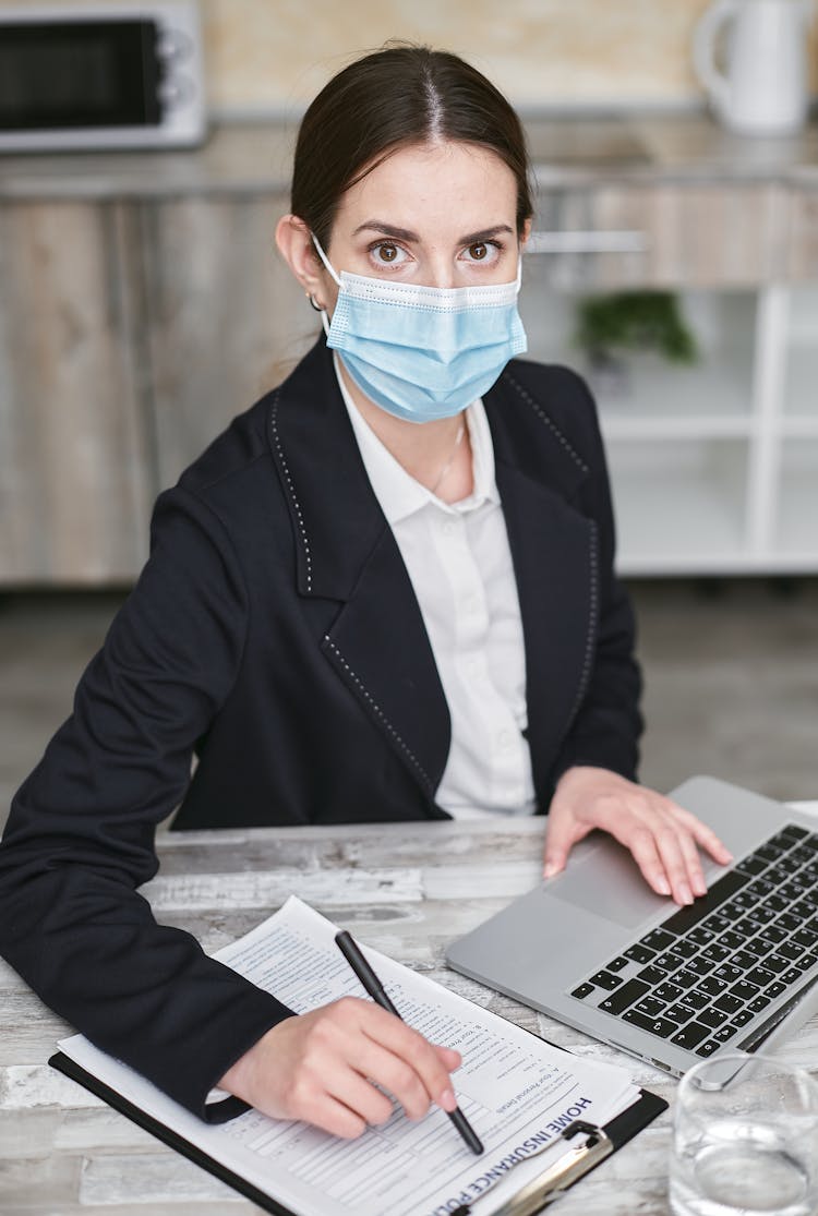 Woman In Black Suit Wearing A Facemask