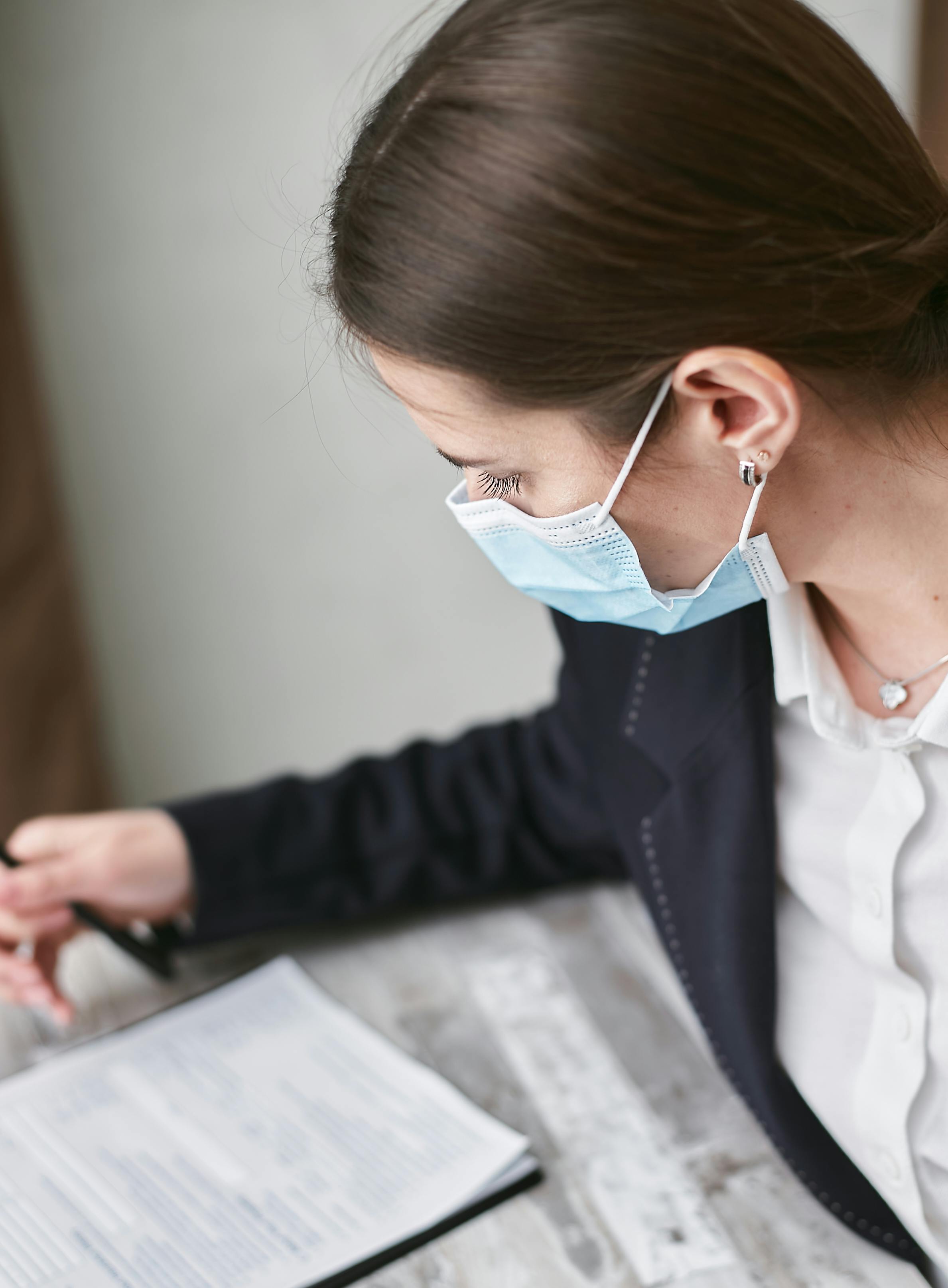 woman in black suit wearing a facemask