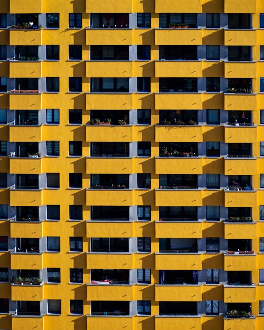 Vibrant yellow apartment building facade in Berlin.
