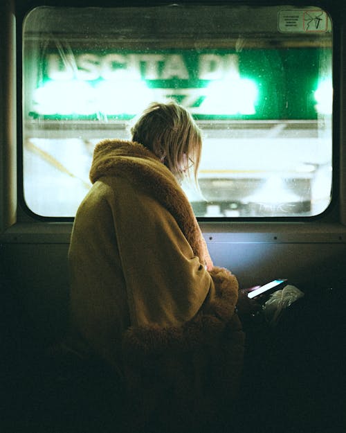 Free Anonymous woman sitting on train Stock Photo