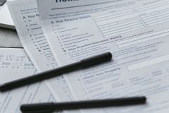 Close-up of home insurance documents with a laptop for financial planning.
