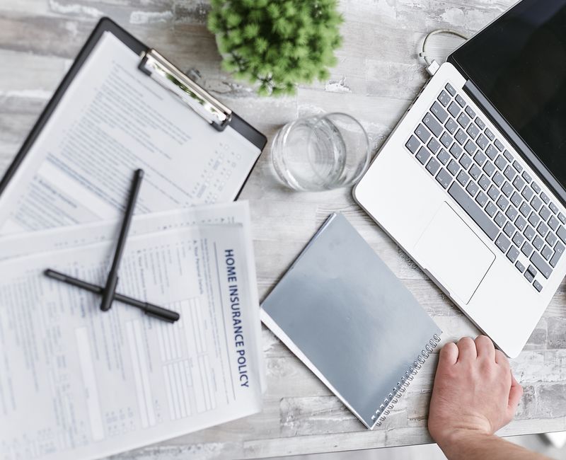Small business owner reviewing AI policies with a laptop