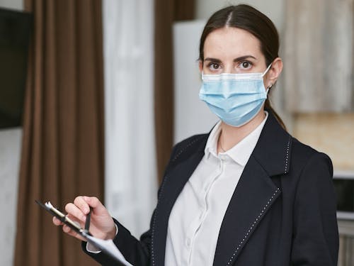 Woman in Black Blazer Holding a Clipboard