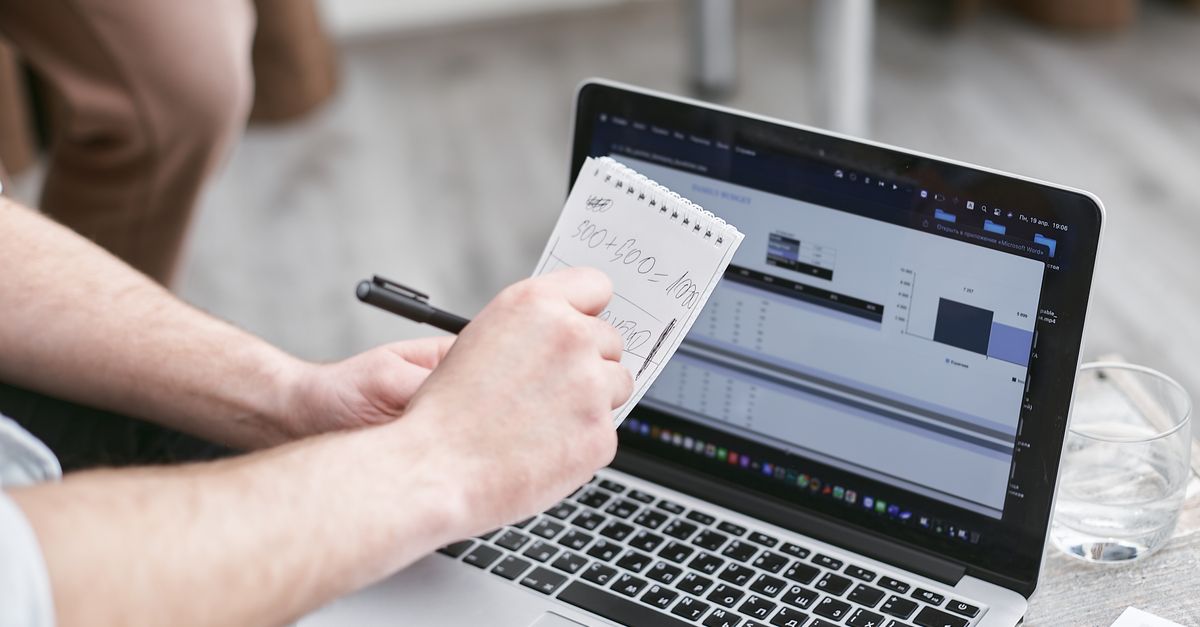 Person Holding Black Pen and Notepad · Free Stock Photo