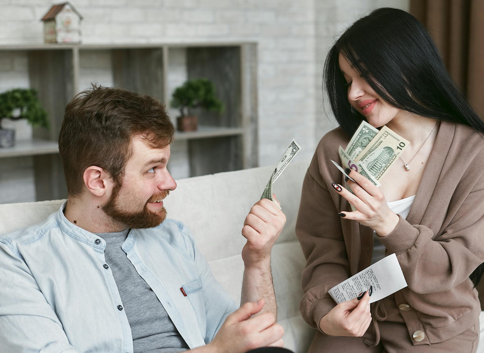 A Man and Woman holding a Money