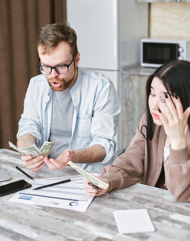 Man And Woman Holding A Money