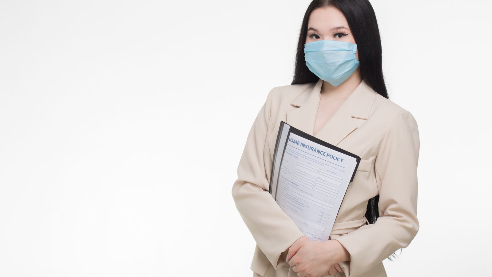 Professional woman wearing face mask holding insurance document, demonstrating safety and business.