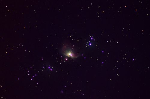 Free Vivid capture of the Orion Nebula amidst a star-filled night sky, showcasing cosmic beauty. Stock Photo
