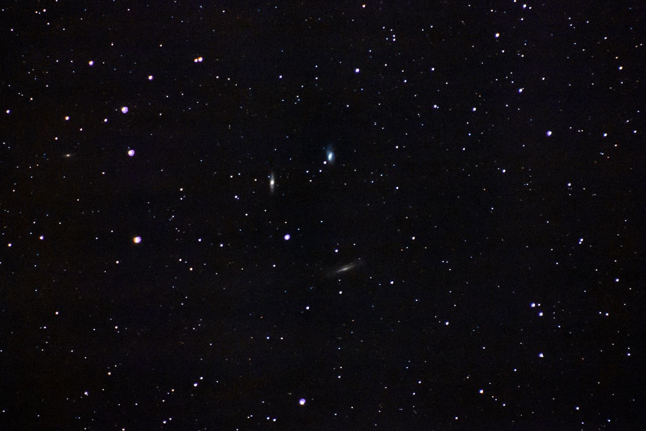 a beautiful wide angle shot of a clear starry night sky featuring dist