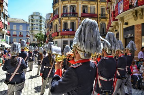 Free A vibrant city parade showcasing a marching brass band in ornate uniforms, captivating the urban audience. Stock Photo