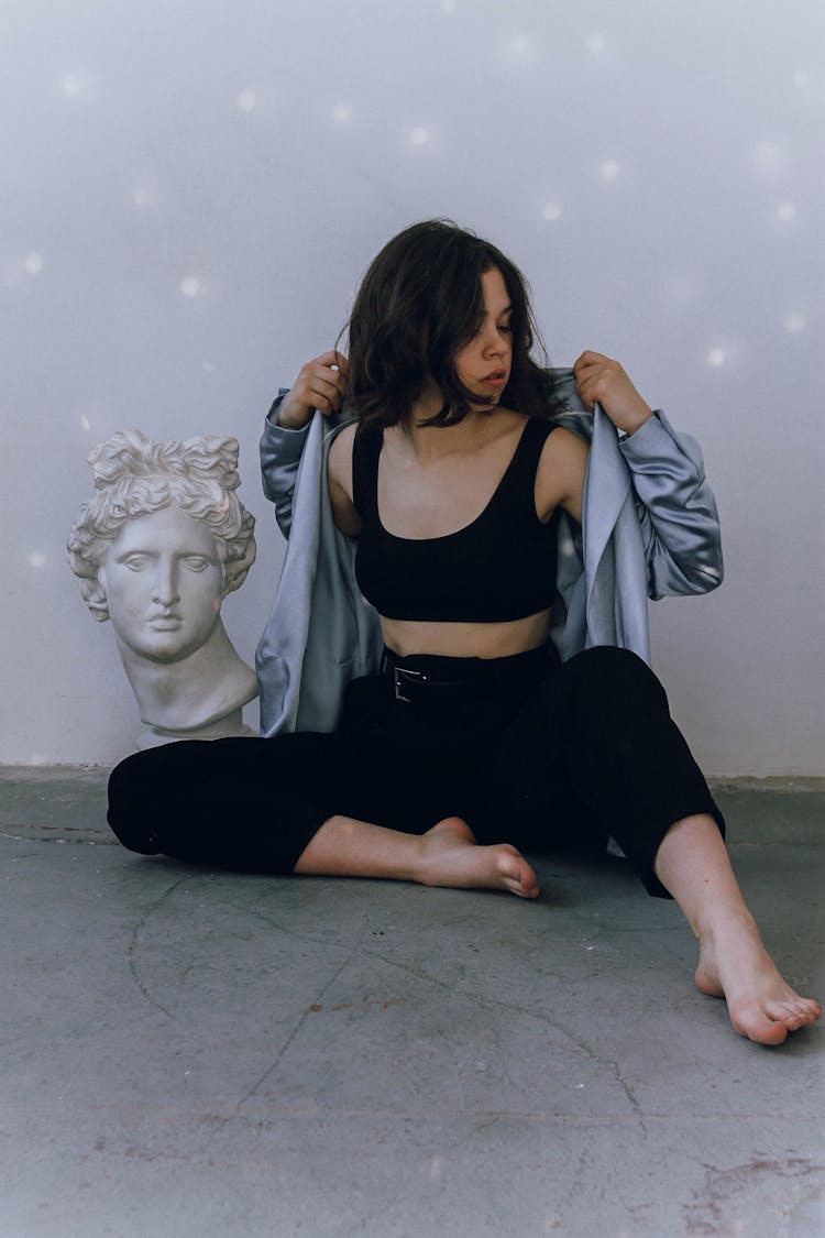 Young Woman Sitting Near Bust