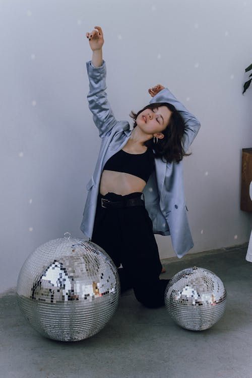 Energetic woman near disco balls