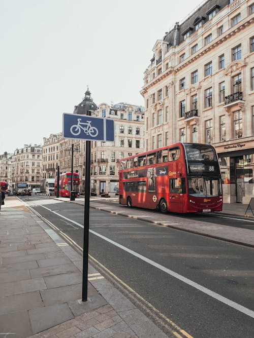 Free Red Double Decker Bus on Concrete Road Stock Photo